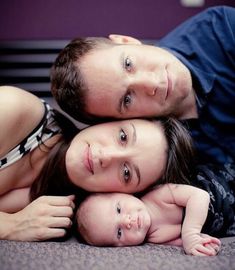 a man and woman laying on top of each other