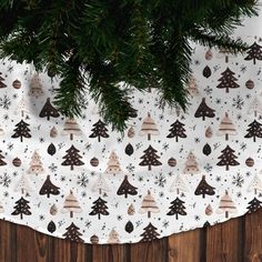 a christmas tree pattern on a white background with brown trees and snowflakes