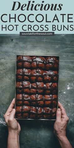 someone holding up a box of chocolate hot cross buns with the title above it