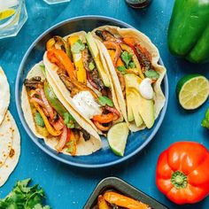 there are many different types of food on the table, including tortillas and peppers