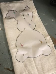 a piece of paper that has been made to look like a rabbit on it's back