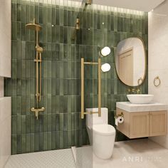 a bathroom with green tiles and gold fixtures on the walls, along with a white toilet and sink