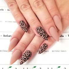 a woman's nails with leopard print on them