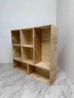 a wooden shelf sitting on top of a white floor