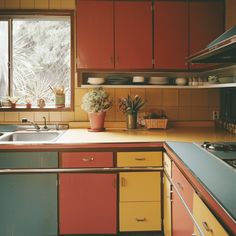 a kitchen filled with lots of counter top space next to a sink and stovetop oven