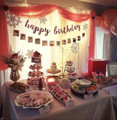 a table filled with lots of food and balloons