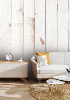 a living room with white furniture and wooden walls