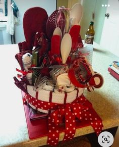 a red and white basket filled with kitchen utensils on top of a counter