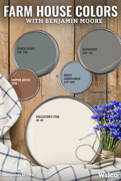 some blue flowers are in a vase and some paint colors on a wooden background with the words farm house colors with benham moore