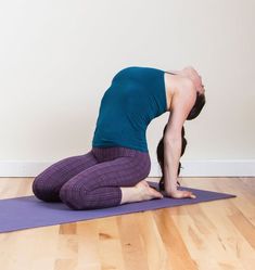 a woman is doing yoga on a purple mat