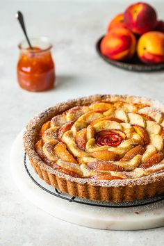 a pastry on a plate next to some fruit