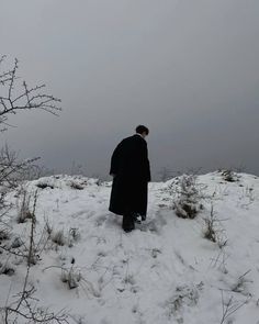 a man standing on top of a snow covered field