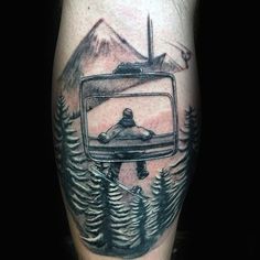 a man's leg with a tv and trees tattoo on the side of his arm