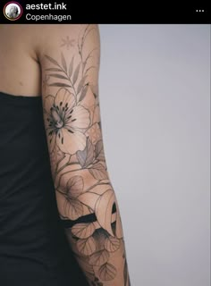 a woman's arm with flowers on it