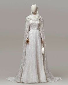 a white gown with long sleeves and a shawl