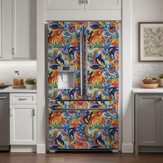 a brightly colored refrigerator in a white kitchen