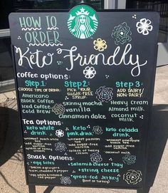 a starbucks menu board sitting on the sidewalk