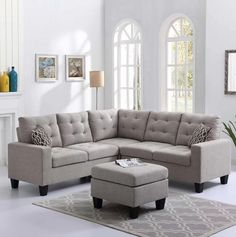 a living room with a sectional couch and ottoman