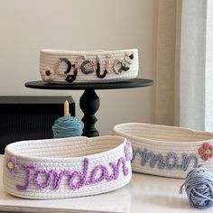 two crocheted baskets sitting on top of a table