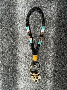 a lanyard with a metal hook and beads on it