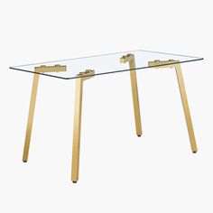 a glass table with gold legs on a white background in the shape of a rectangle