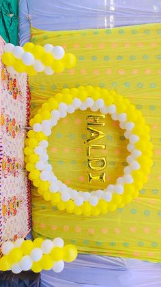 a yellow and white bracelet with the word happy spelled out in gold letters on it