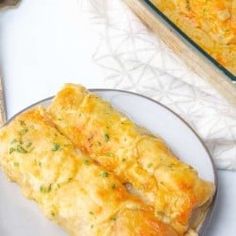 an omelet on a plate next to a casserole dish and utensils