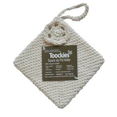 a white crocheted pot holder with a tag on the front and back of it