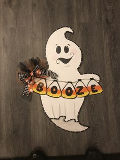 a paper cut out of a ghost holding a sign that says booooze on it