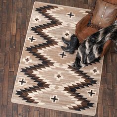 a brown and white rug sitting on top of a wooden floor