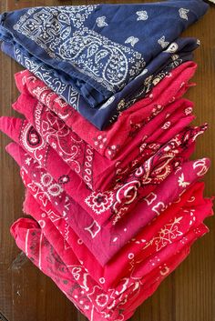 a stack of bandanas sitting on top of a wooden table