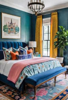 a bedroom with teal walls, blue bedding and orange drapes on the windowsill