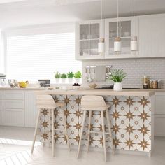 two stools are sitting at the bar in this white and blue kitchen with tile backsplash