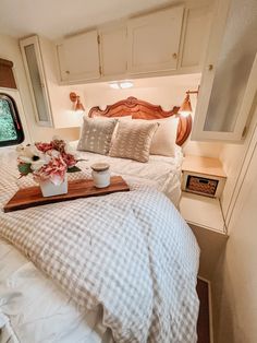 a tray with flowers on top of a bed