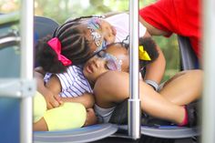 three children are sleeping on the back of a bus with their faces painted like clowns