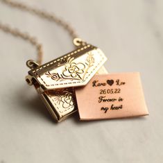 This engraved personalised envelope locket comes with a personalized letter inside, engraved with any message you choose! Your message will be beautifully engraved on a solid copper letter in our Edinburgh studio, and can be personalised in a choice of five beautiful fonts. Please check our photos for a Font Guide. The locket is made from gold plated brass. The front and back of the locket are decorated with a charming botanical leaf design. The locket measures just one inch (2.5cm) across, and Jewelry Engraving, Envelope Necklace, Font Guide, Gold Envelope, Engraved Locket, Gold Locket Necklace, Gold Envelopes, Personalised Jewellery, Personalized Bridesmaid Gifts