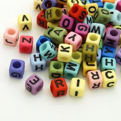 colorful plastic letters and numbers are scattered on a white surface