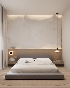 a large bed sitting in the middle of a bedroom next to a wall mounted light