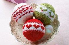 three knitted ornaments in a glass bowl