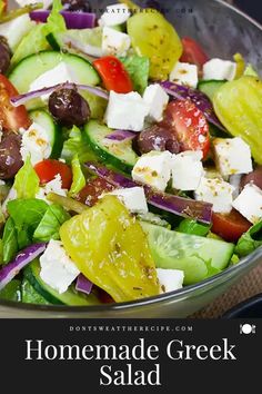 a salad with tomatoes, cucumbers, olives and feta cheese in it