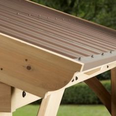 a wooden bench sitting on top of a lush green field