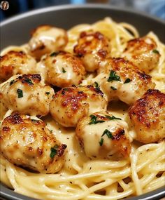 pasta with scallops and parmesan cheese in a bowl