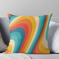 a colorful throw pillow sitting on top of a couch