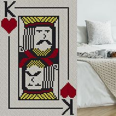 a bed with a white comforter on top of it next to an image of a king of hearts