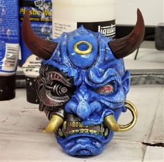 a blue mask with horns on top of a counter