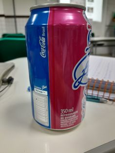 a can of soda sitting on top of a table