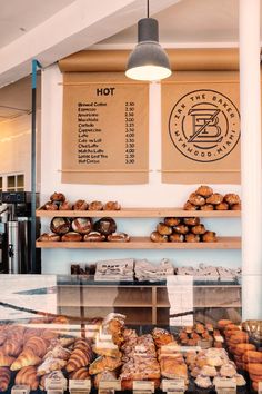 a bakery with lots of pastries on display in front of the counter and menu