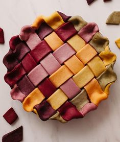 a close up of a pie on a table with other food items around the edges