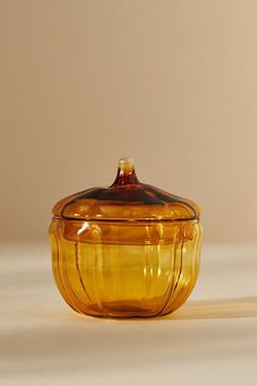 a yellow glass bowl sitting on top of a table