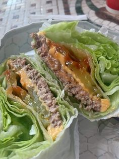 two lettuce wraps filled with meat and sauce